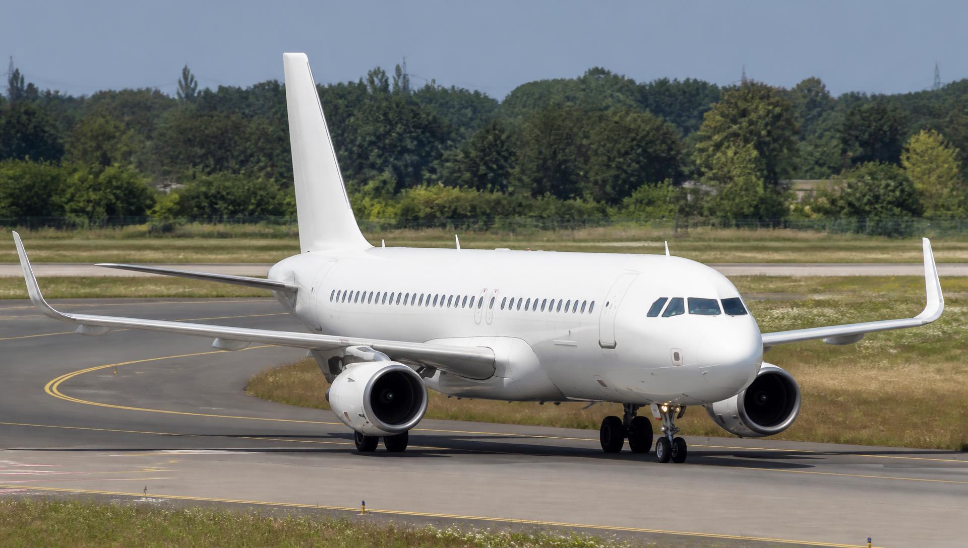 Airbus A320 family taxiing on an airport taxiway in daylight