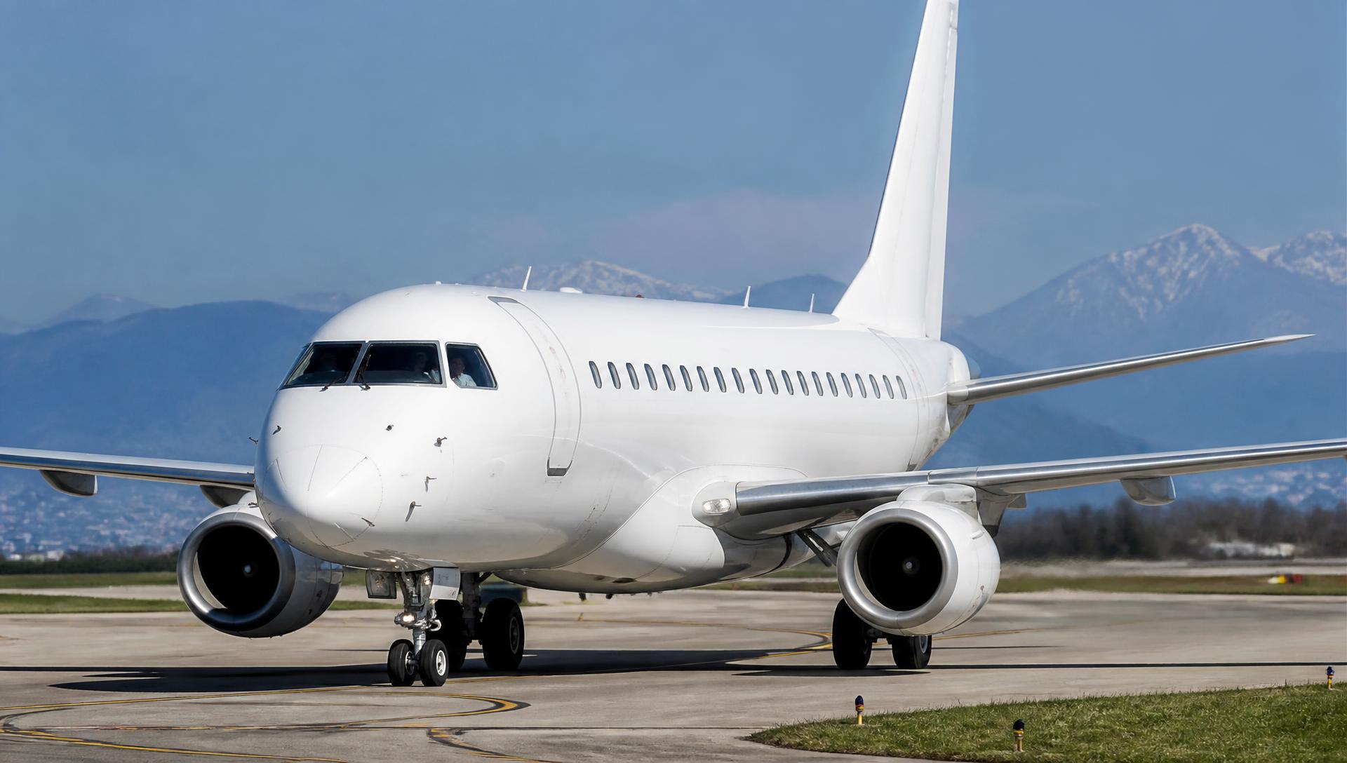 Embraer E-Jets taxiing on an airport taxiway in daylight